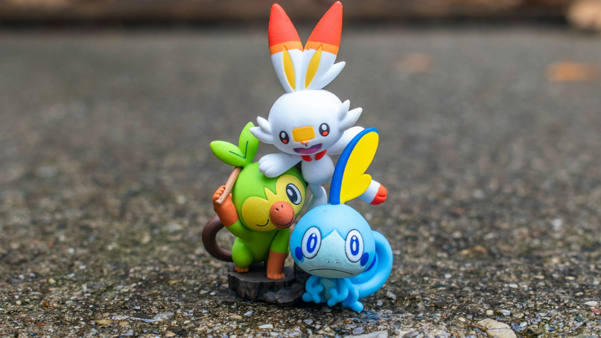 a group of pokemon figurines sitting on top of a rock