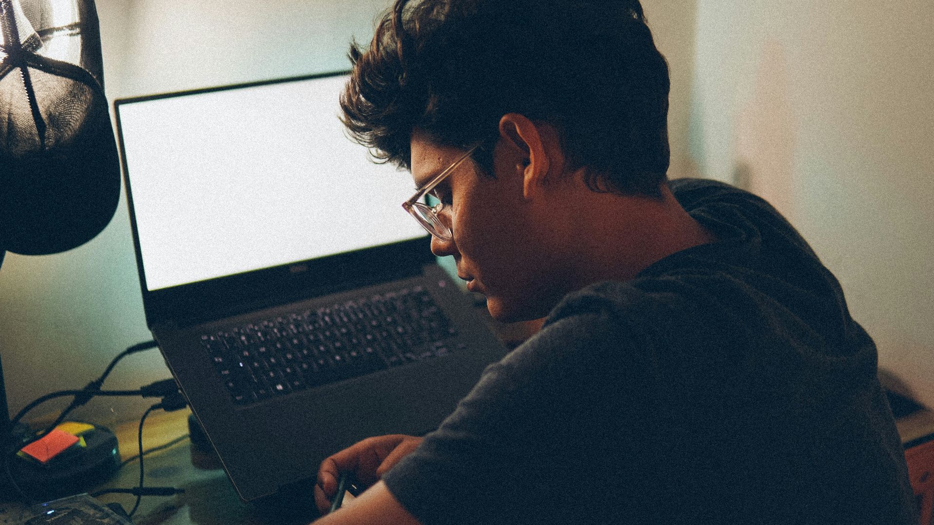 a man sitting in front of a laptop computer