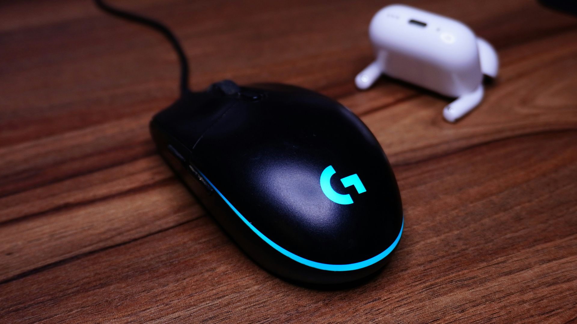 A computer mouse sitting on top of a wooden desk