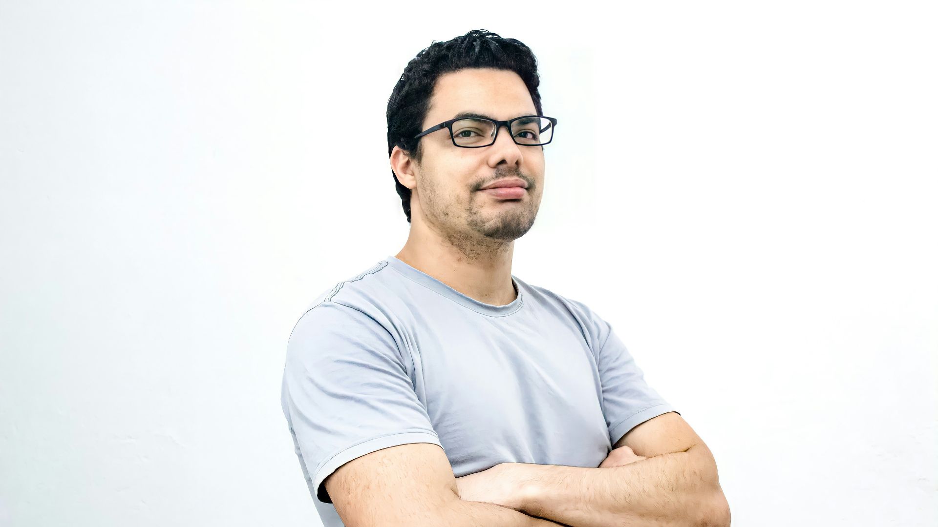 man in white crew neck t-shirt wearing black framed eyeglasses