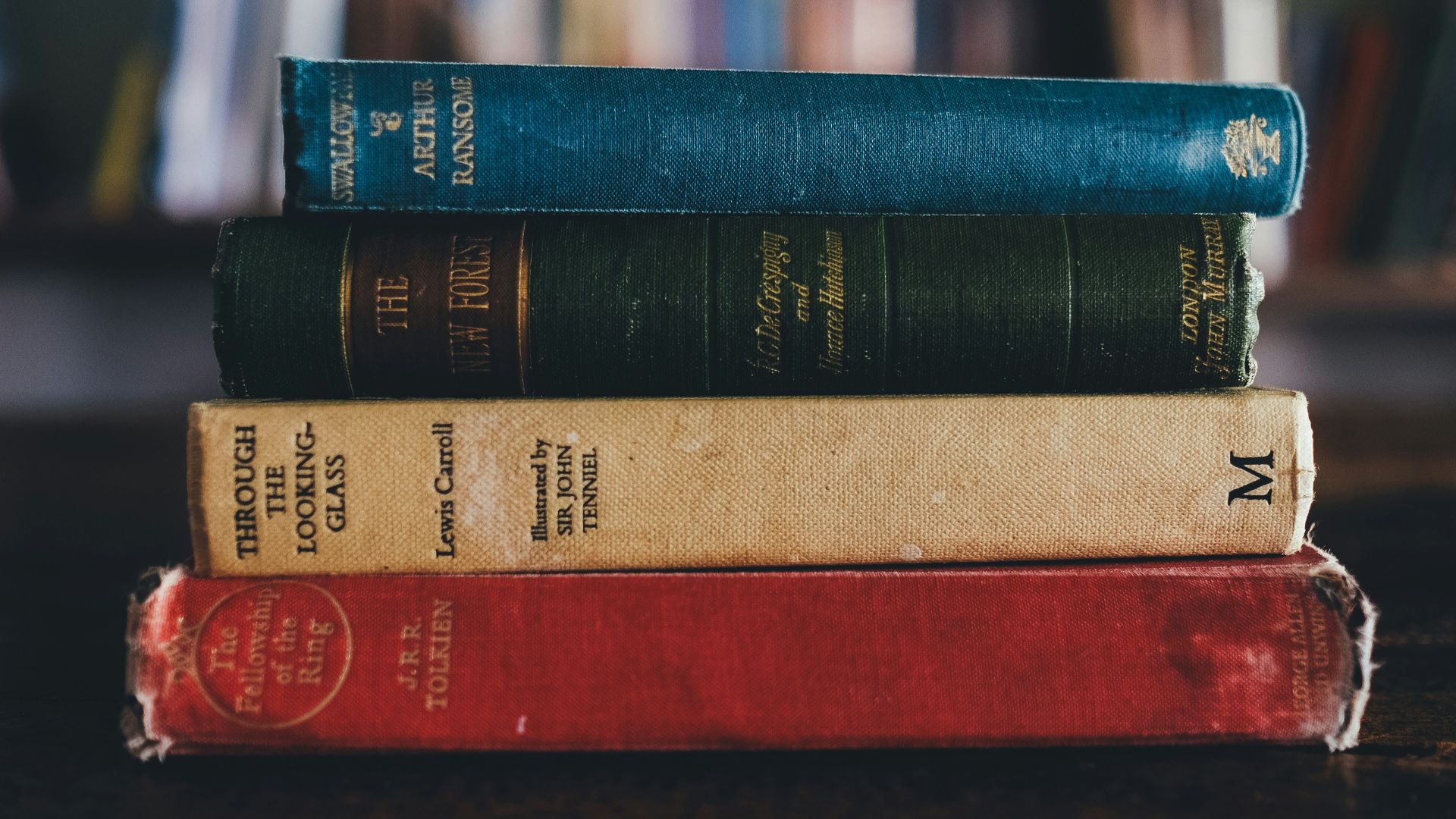 four assorted reading books on brown surface