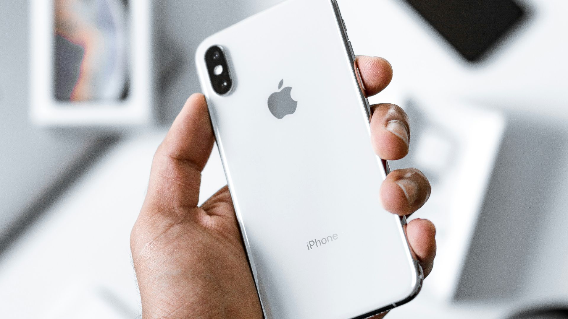 person holding silver iPhone X