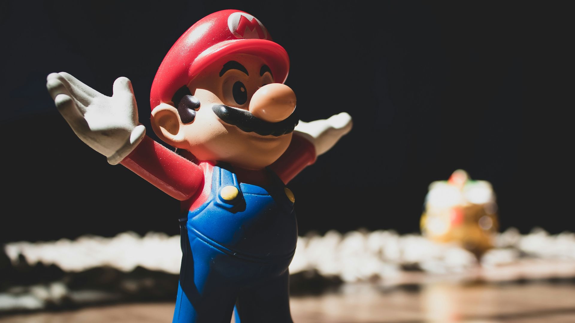 Super Mario figurine on brown surface