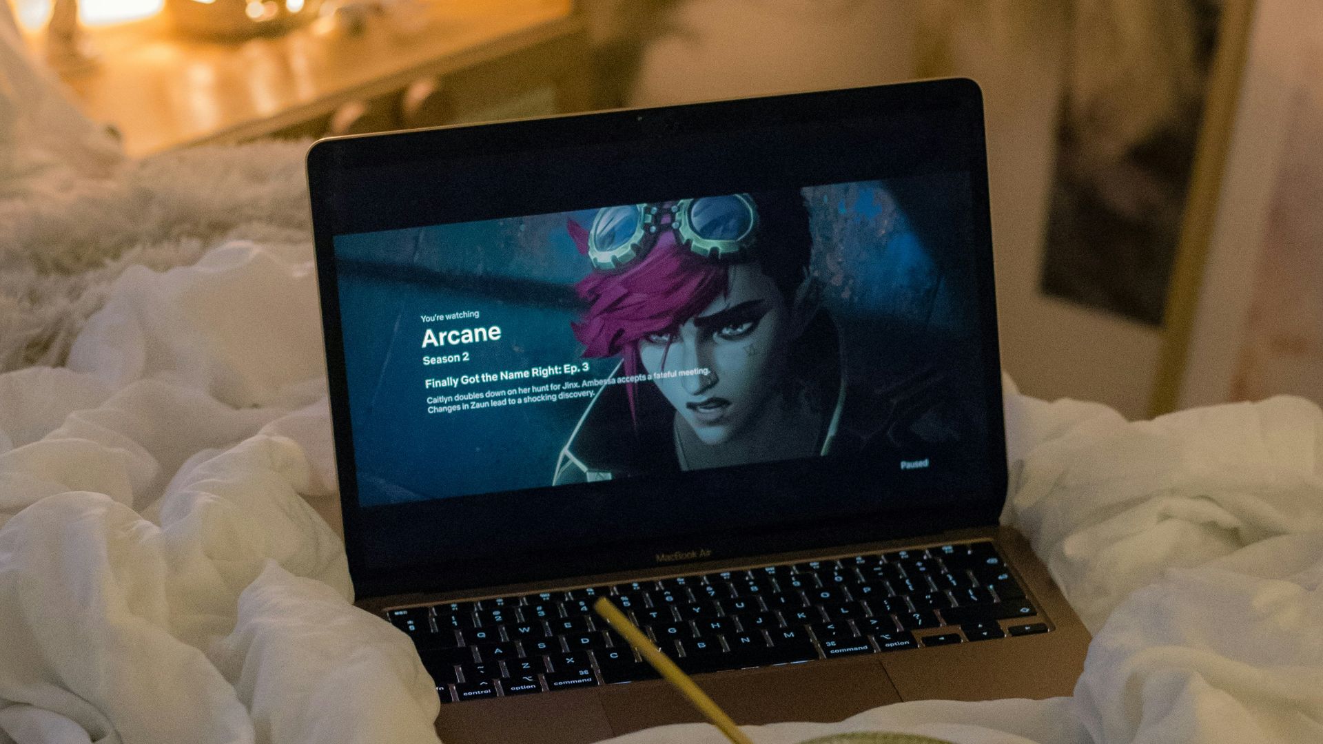 A laptop computer sitting on top of a bed