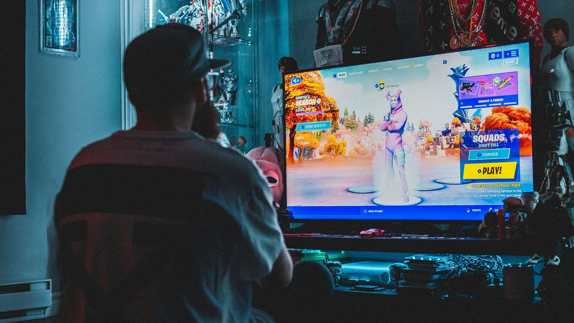 man in red shirt watching tv