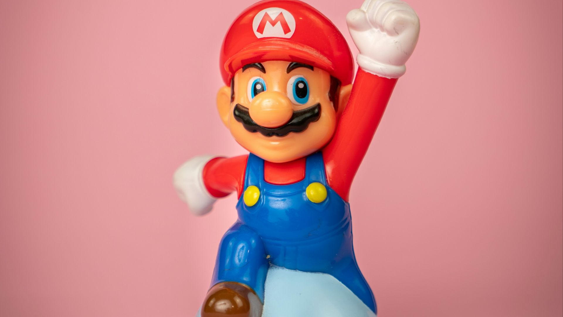 a toy figure of mario on top of a blue object