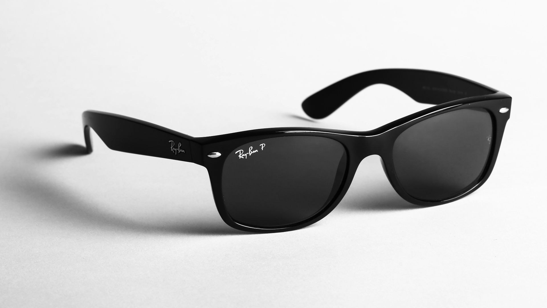 shallow focus photo of black Ray-Ban wayfarer sunglasses