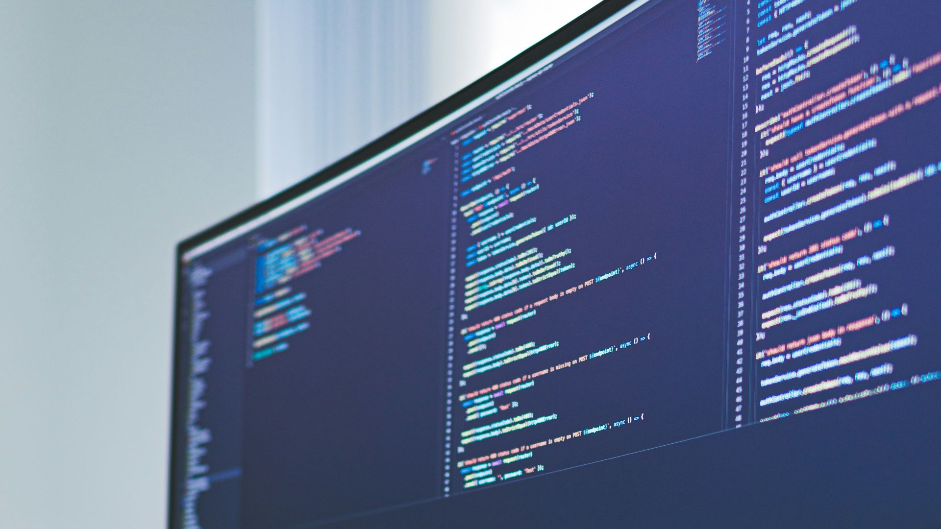 a computer monitor sitting on top of a wooden desk