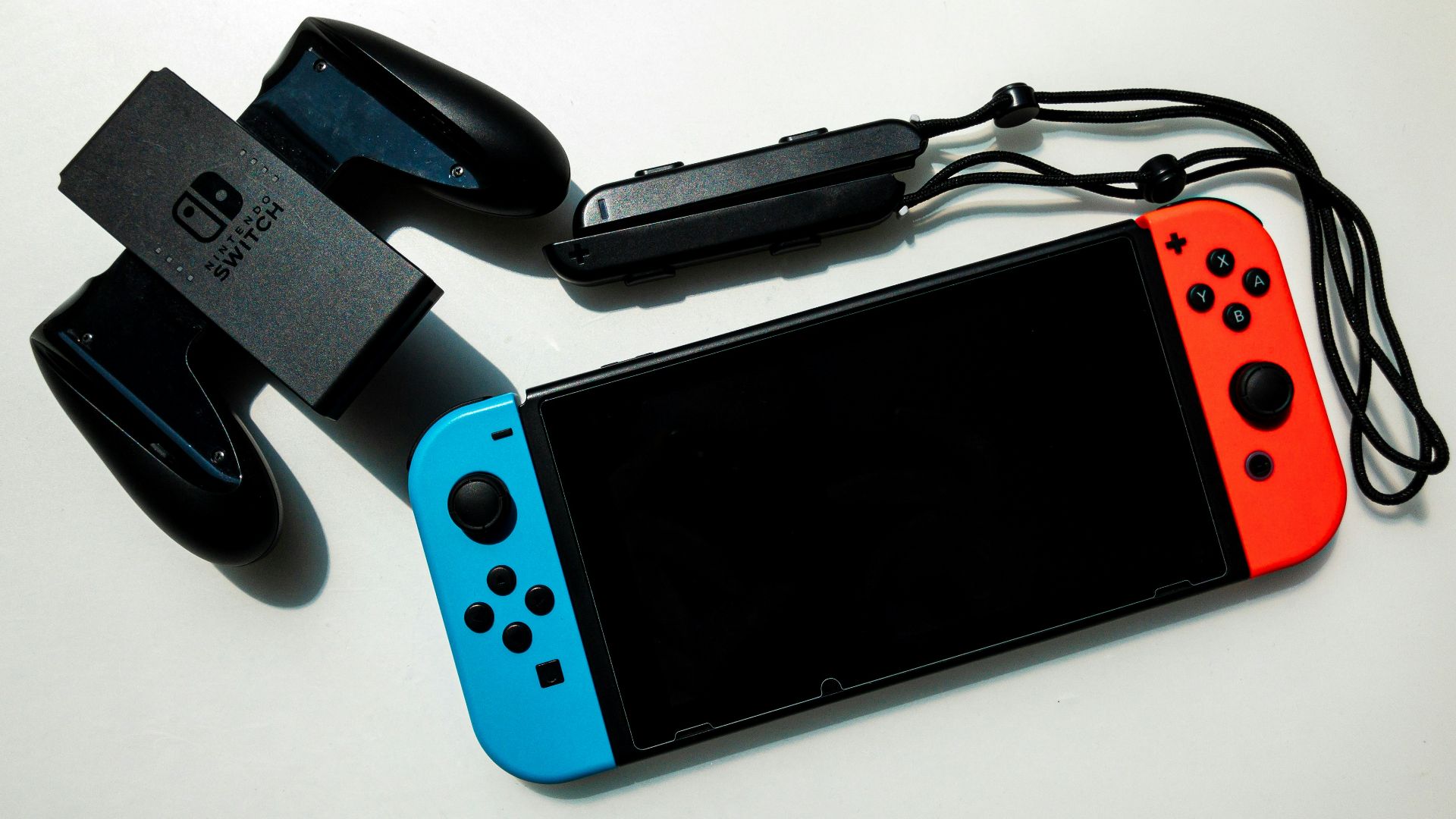 white nintendo switch beside black usb flash drive