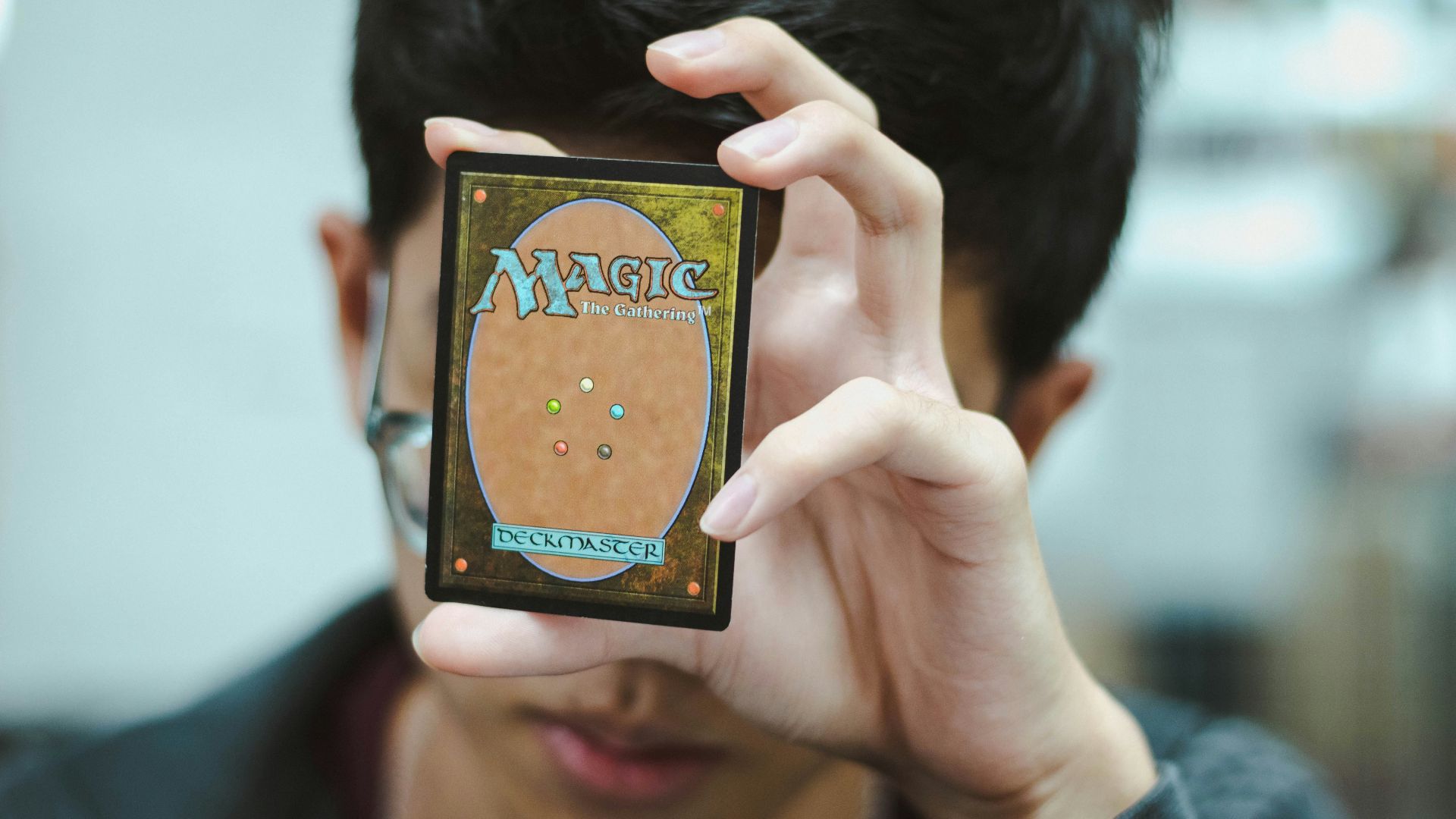 boy holding Magic: The Gathering trading card