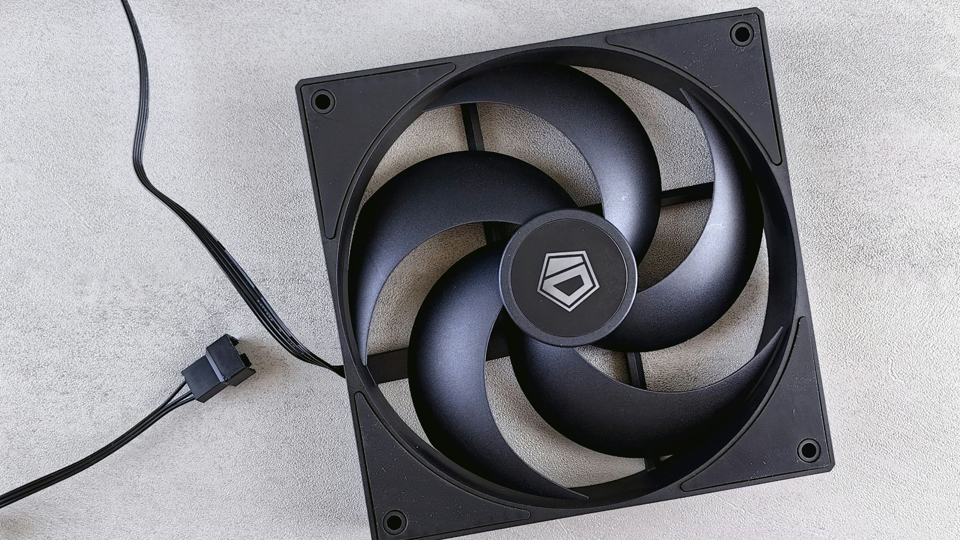 A computer fan sitting on top of a white surface