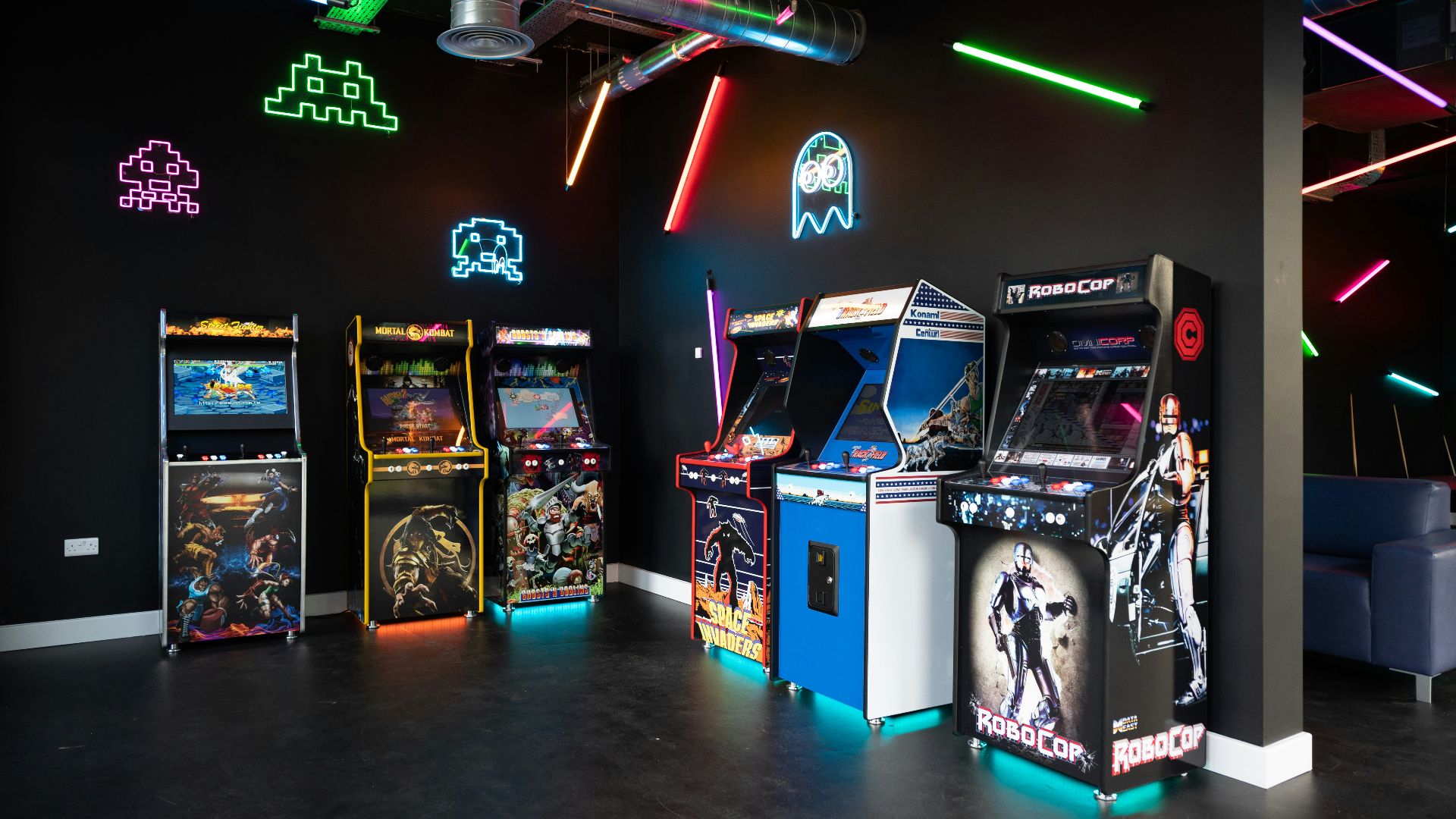 a room filled with arcade machines and neon lights