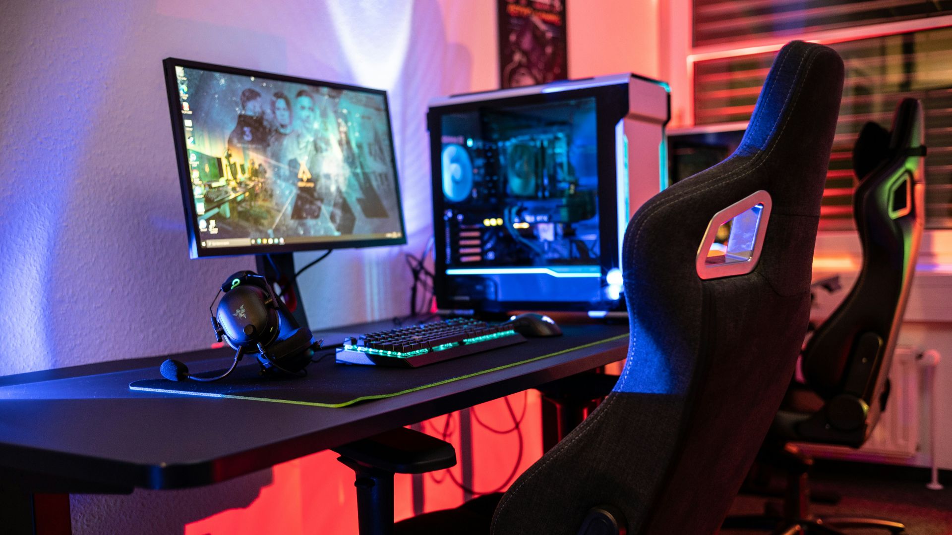 a desk with a computer and a gaming chair