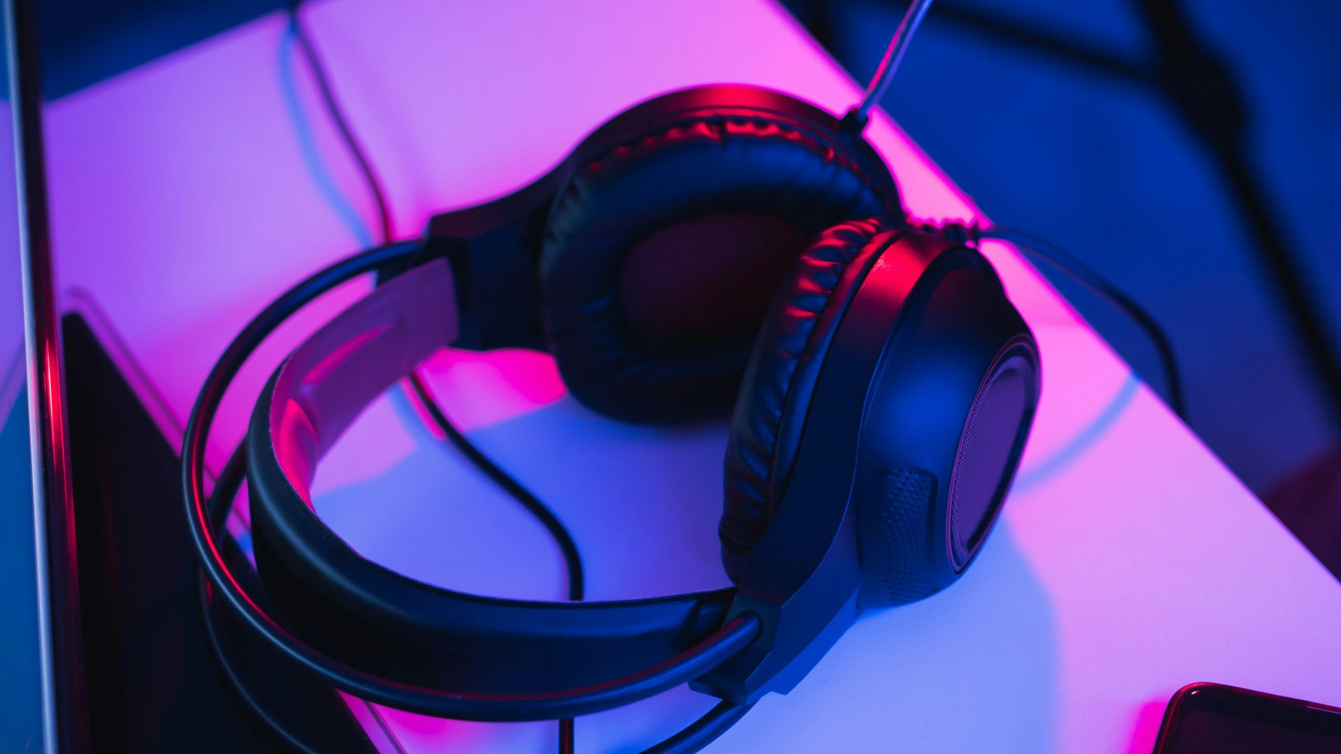 black and red corded headphones on white table