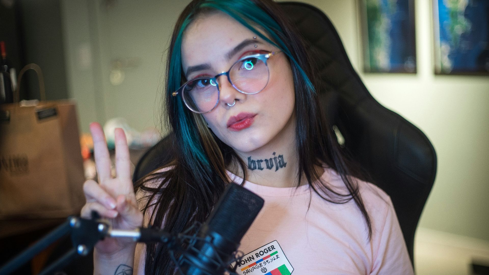 woman in pink crew neck t-shirt wearing black framed eyeglasses