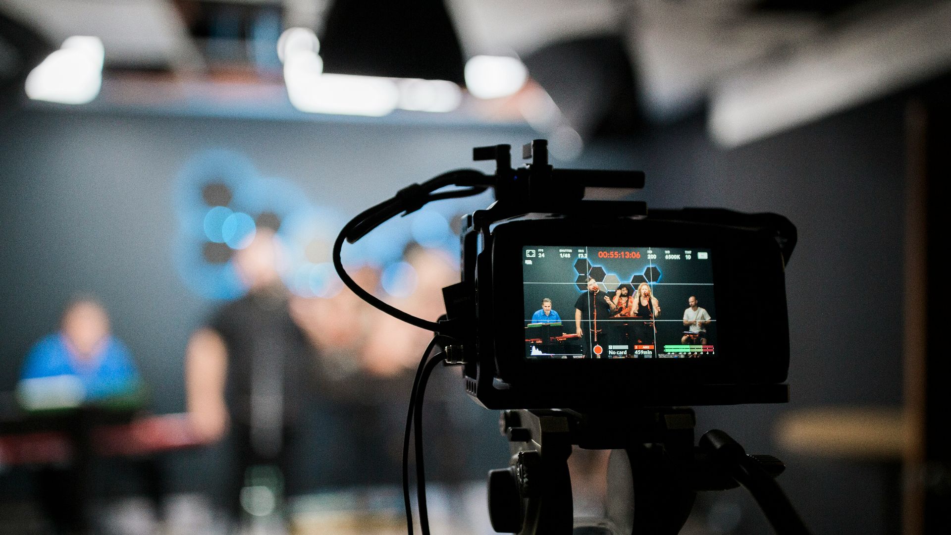 black dslr camera taking photo of city lights