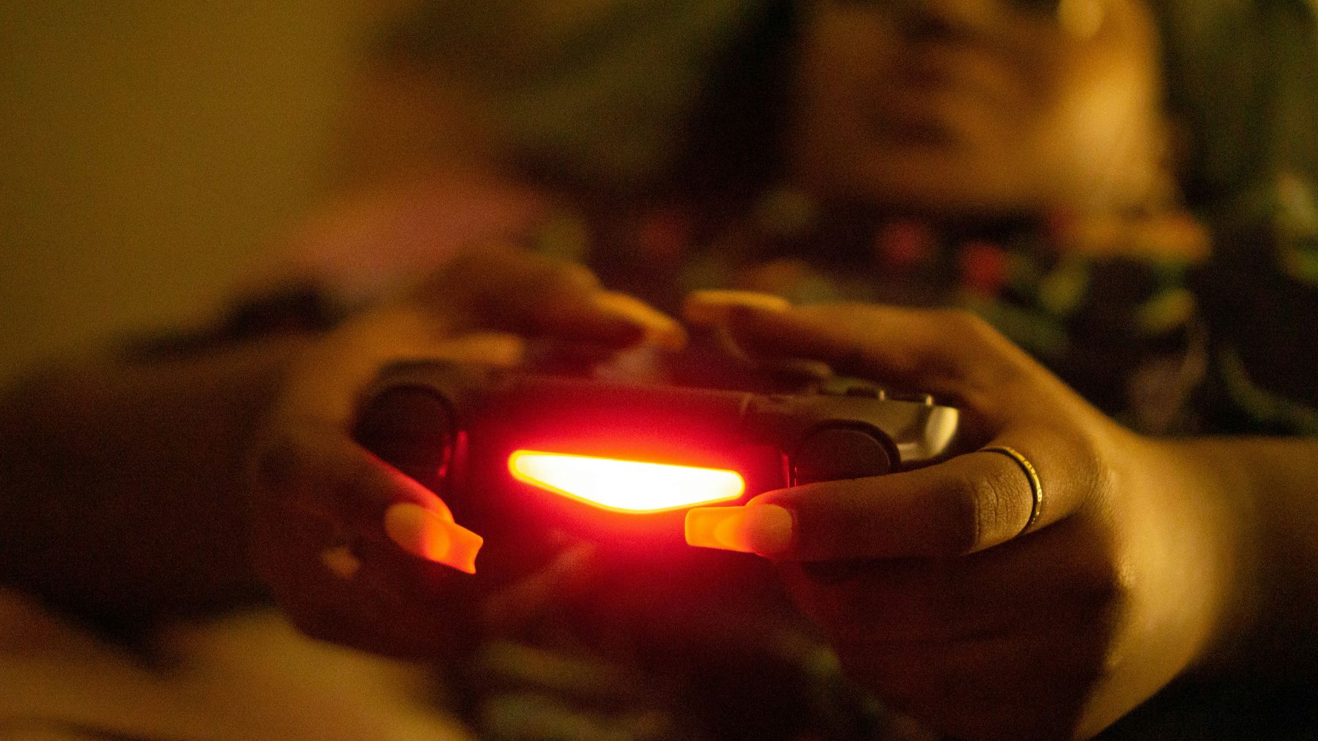 a close up of a person holding a game controller