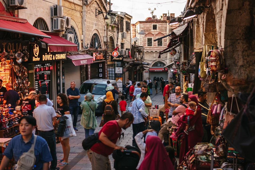 a crowd of people walking through a busy street