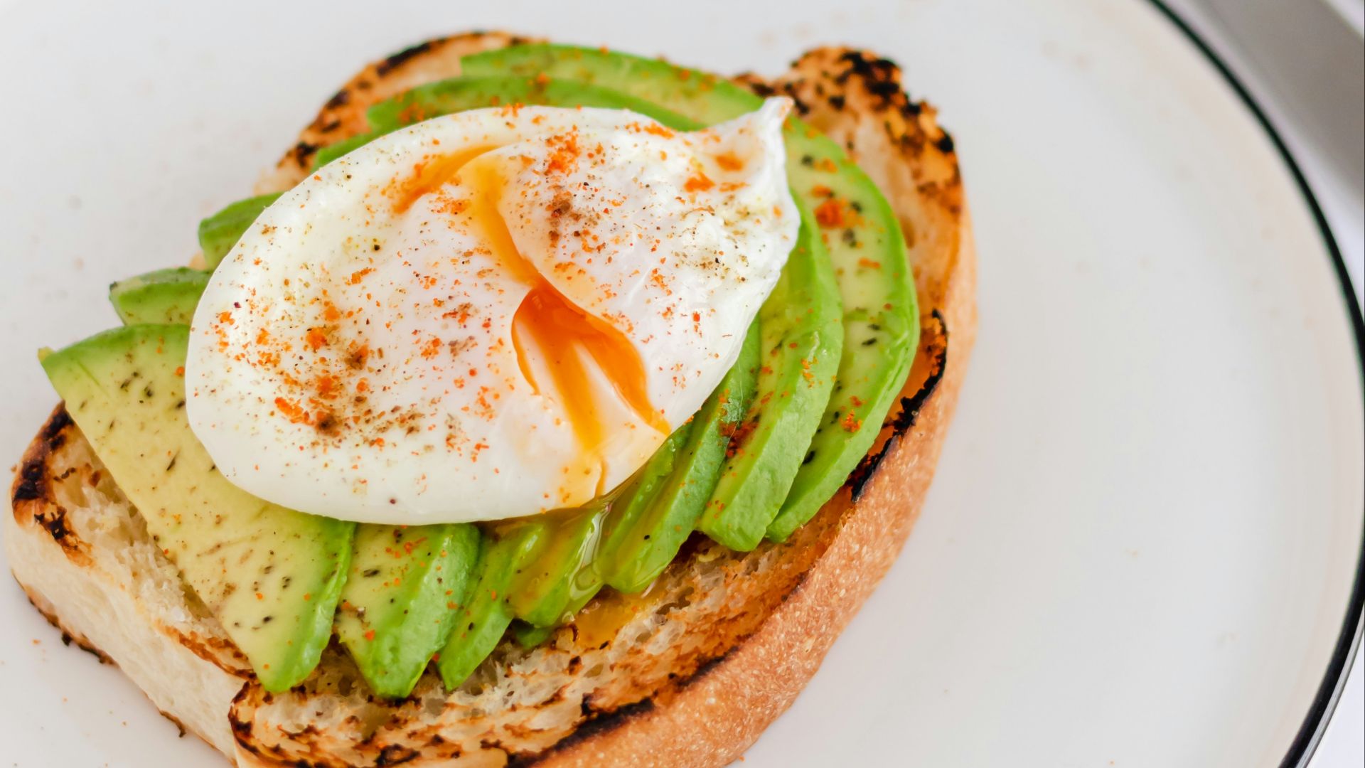 a sandwich with an egg and asparagus on it