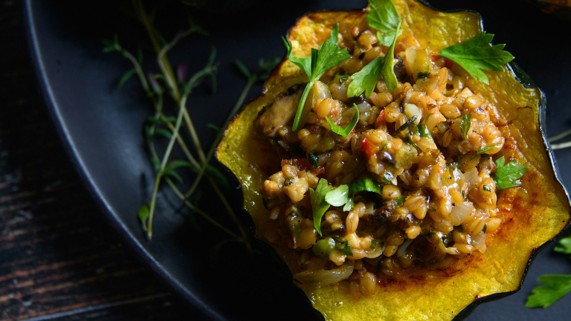 a black plate topped with three stuffed acorns