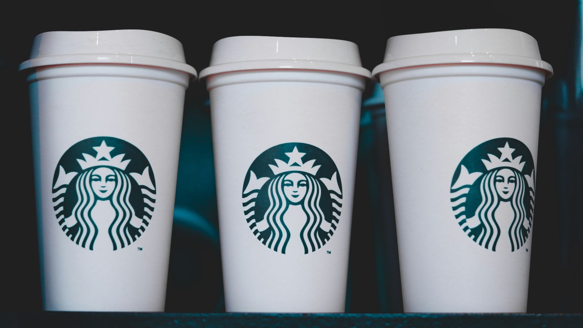 two white starbucks disposable cups