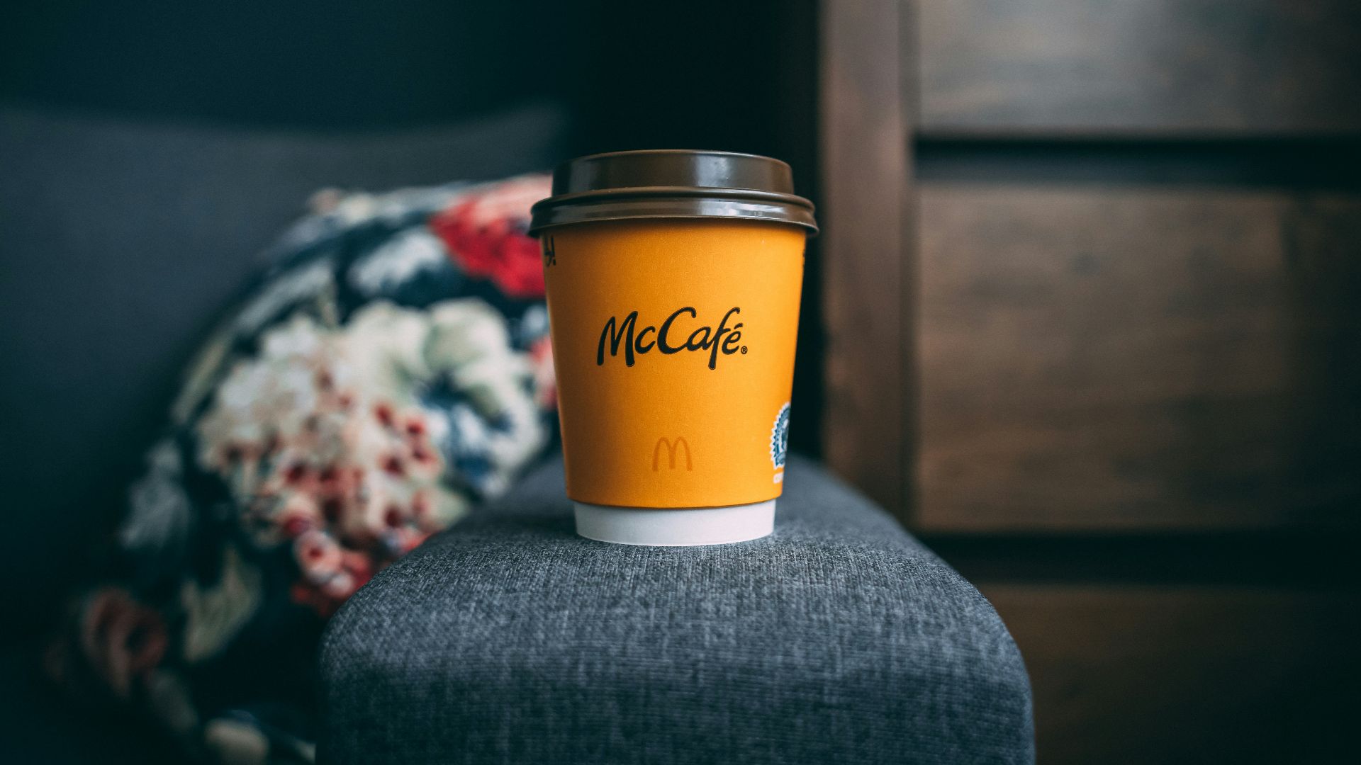 a cup of coffee sitting on top of a chair