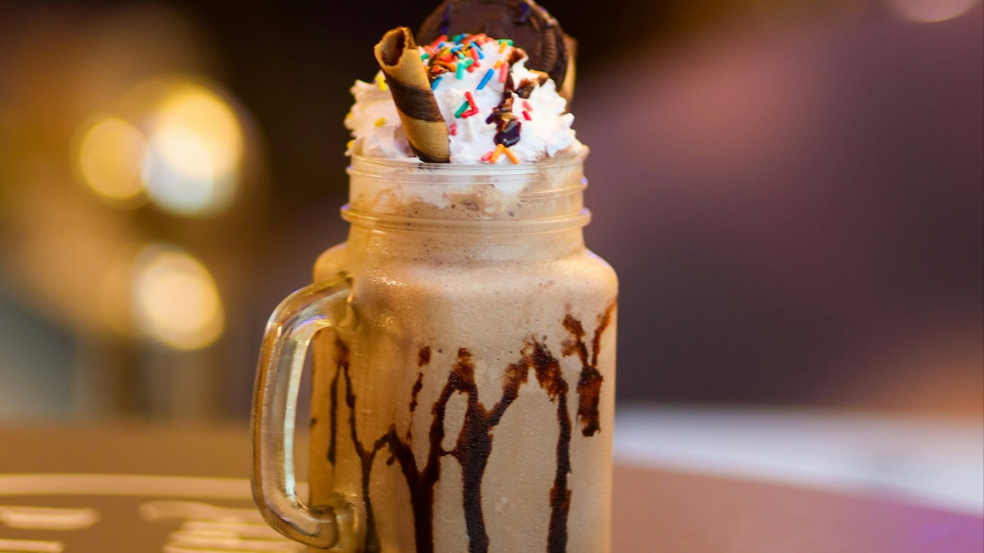 a chocolate milkshake with sprinkles on top