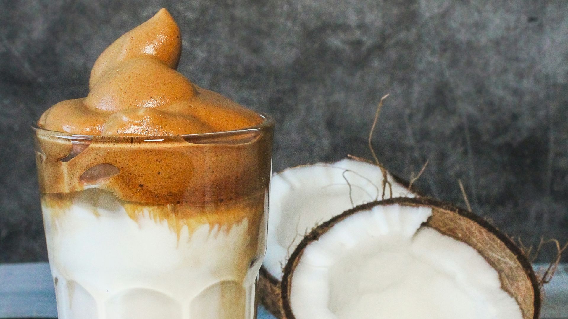 clear drinking glass with white liquid and orange slice
