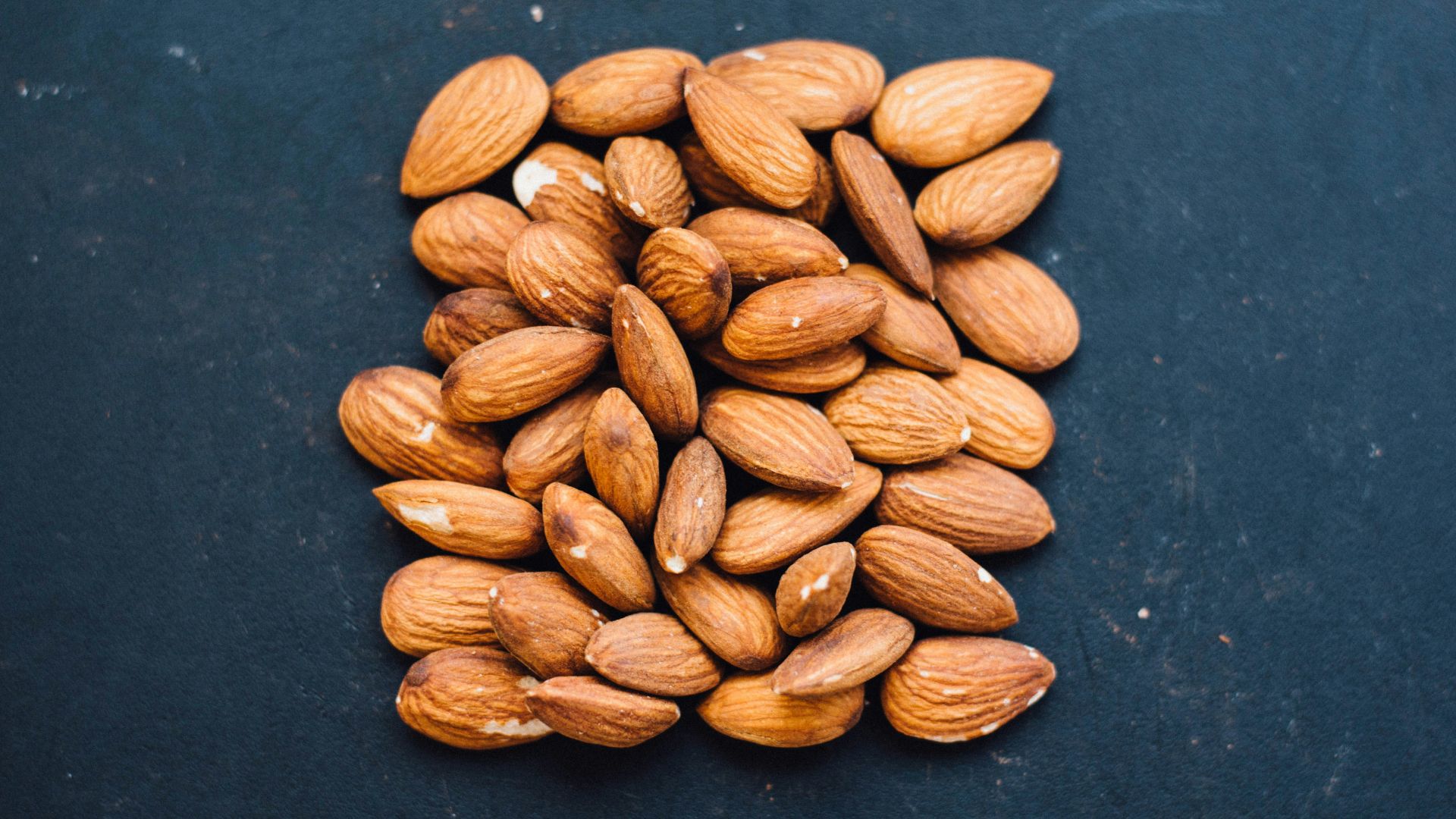 brown nuts on black surface