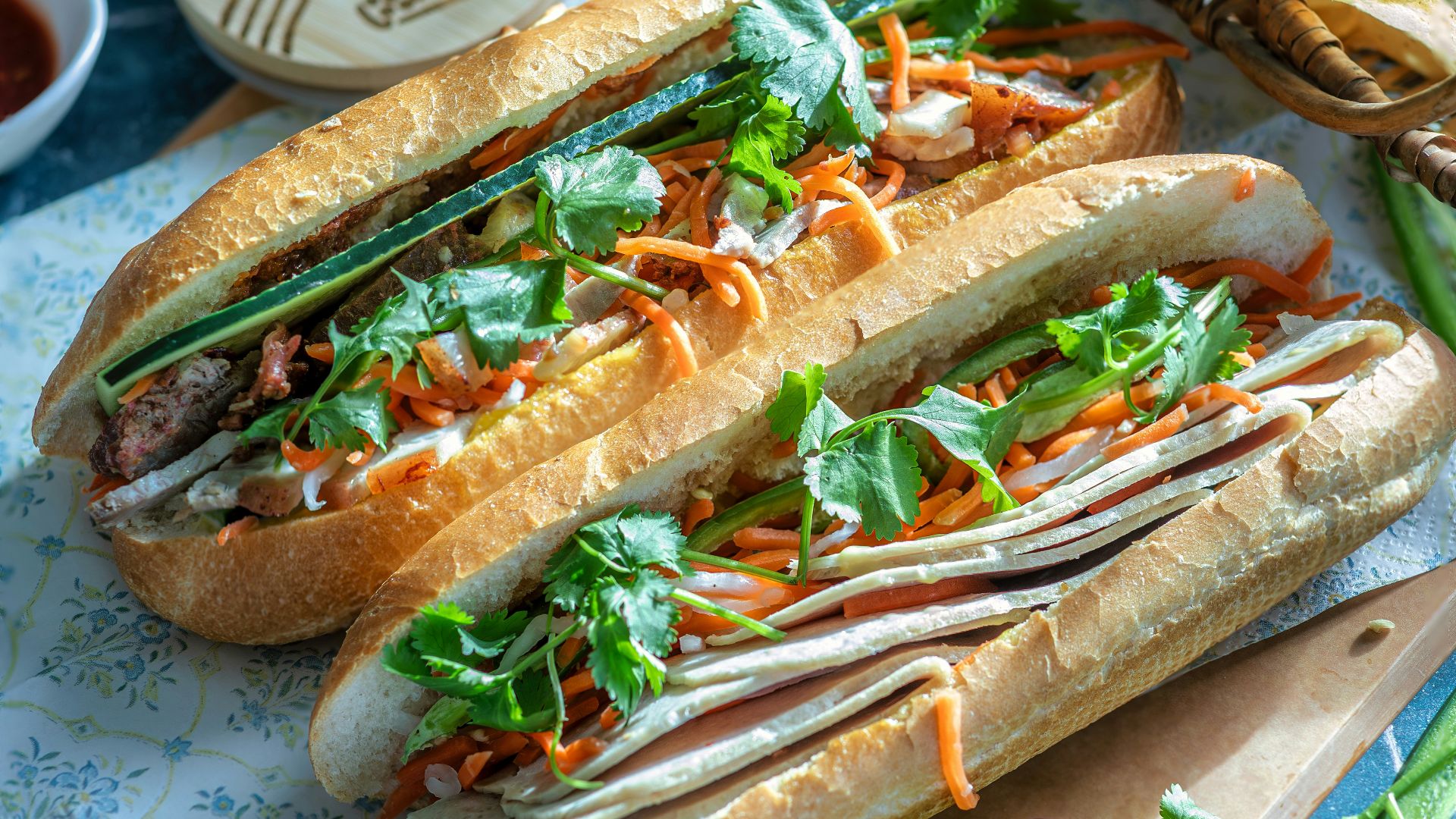 a couple of sandwiches sitting on top of a cutting board