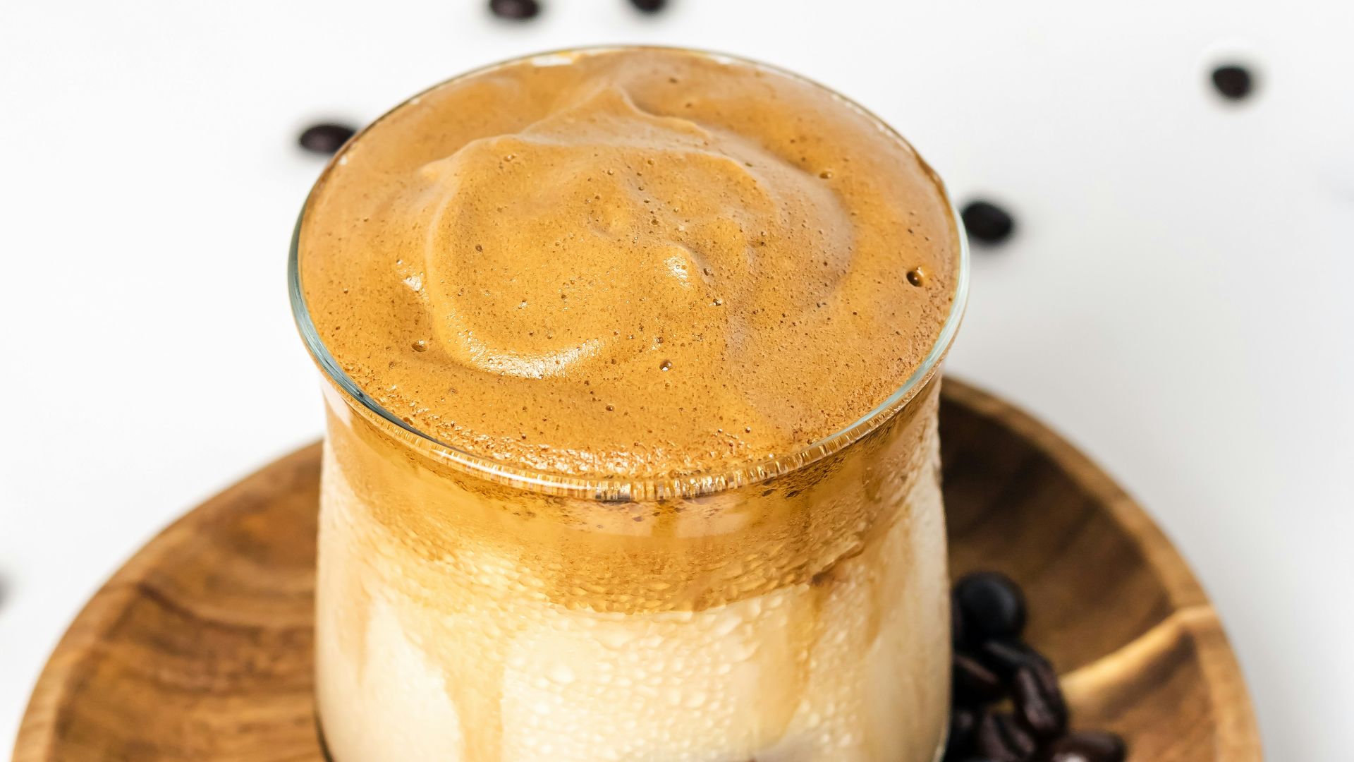 a cup of coffee sitting on top of a wooden plate