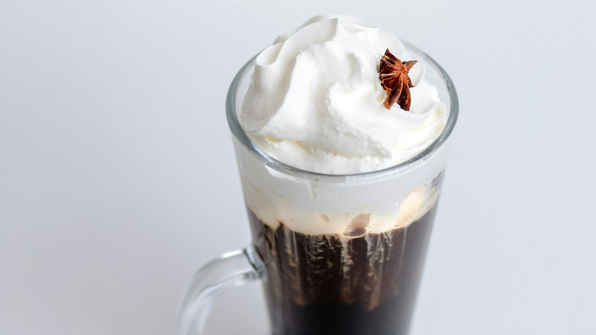 A cup of coffee with whipped cream on top