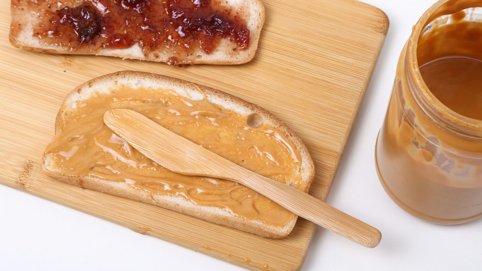 a wooden spoon next to a bowl of food