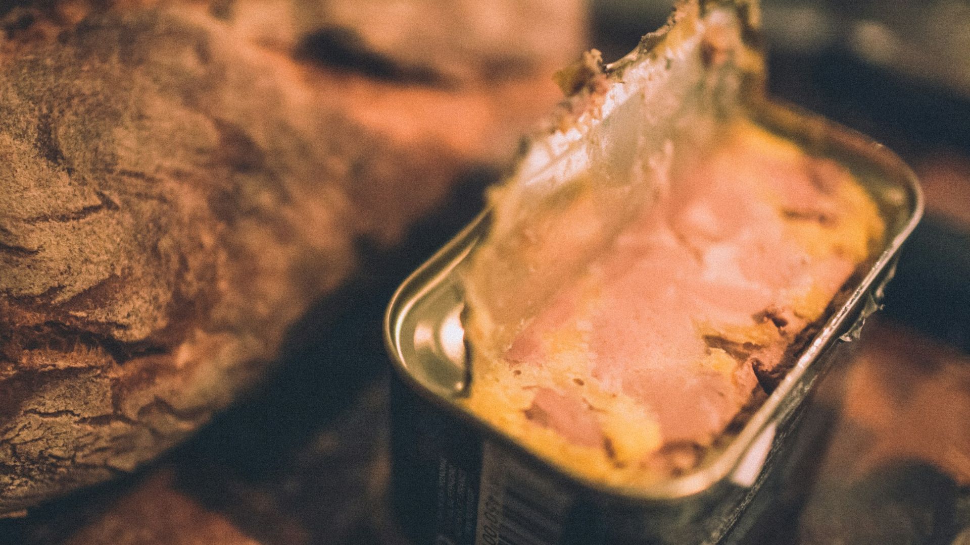 a loaf of bread sitting next to a can of food