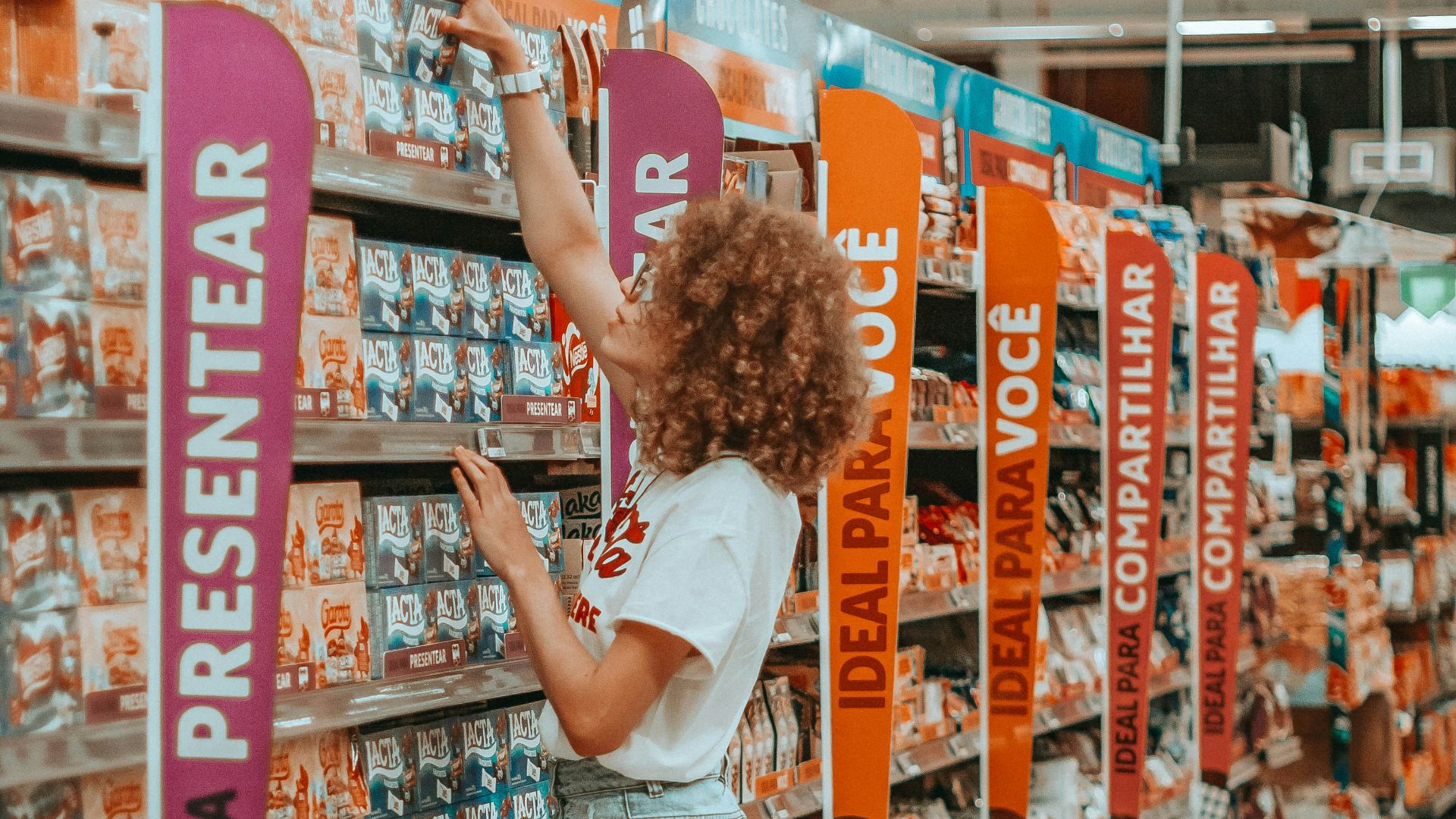 woman getting box of chocolate inside grocery