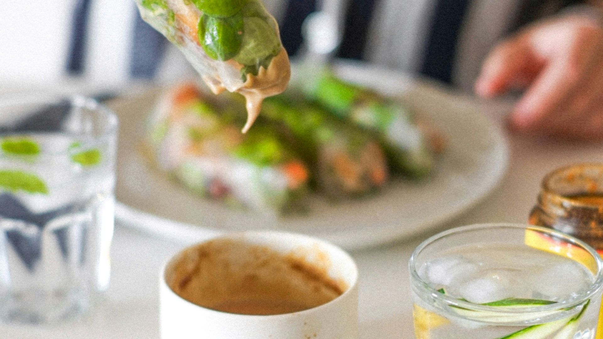 a person putting a piece of food on top of a plate
