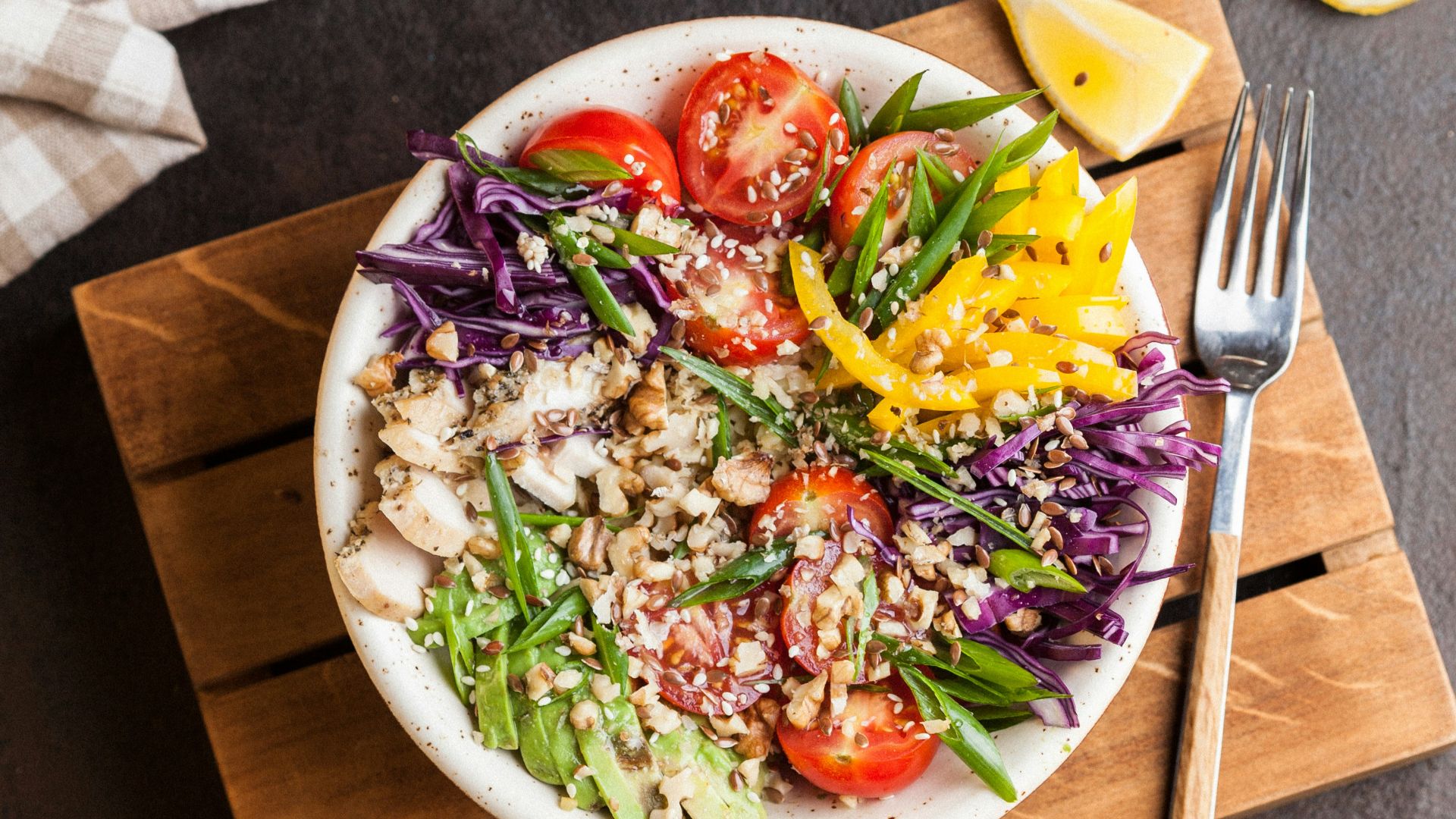 plate full of salad with spice on top of brown board