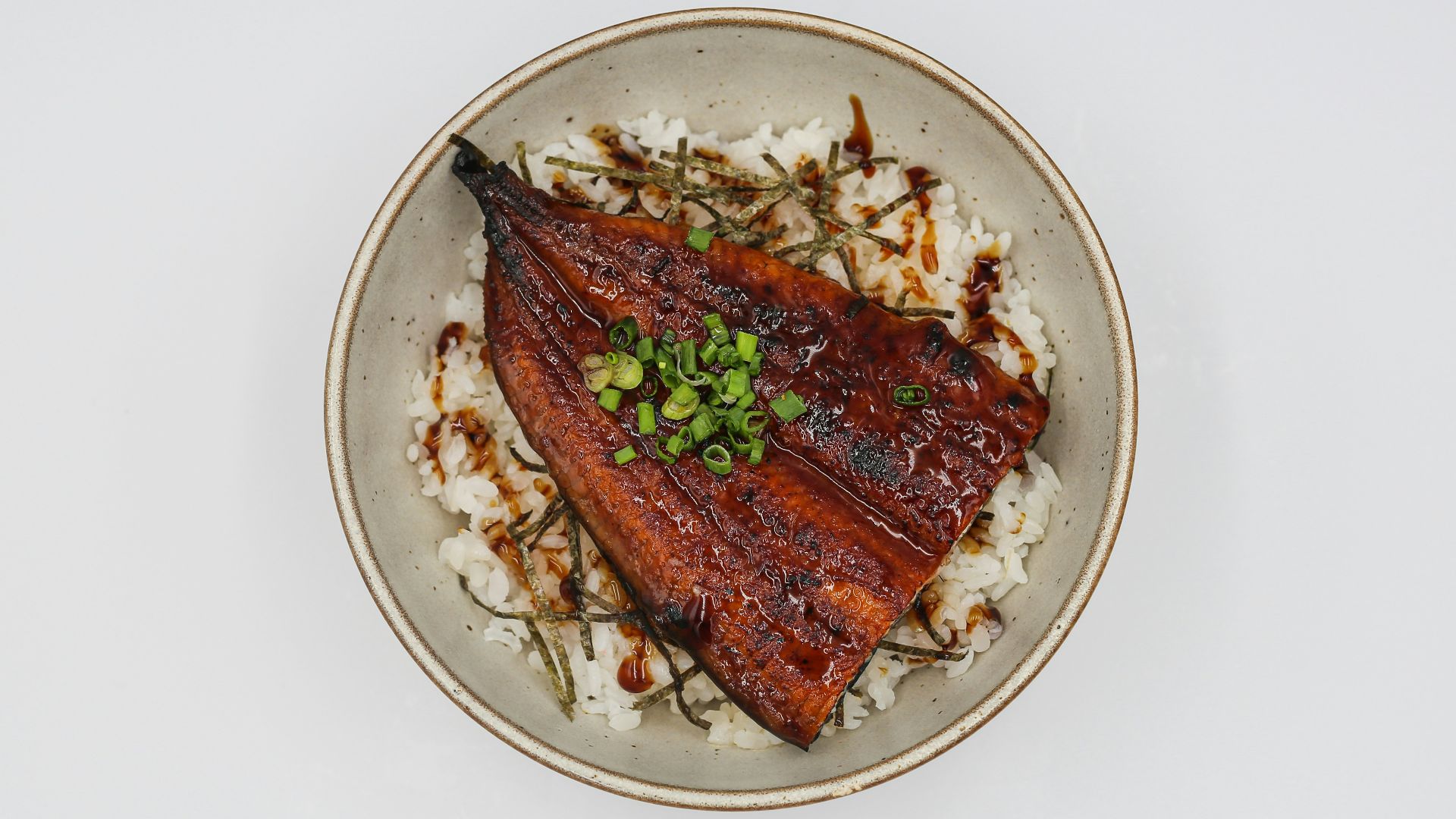 a white plate topped with meat and rice