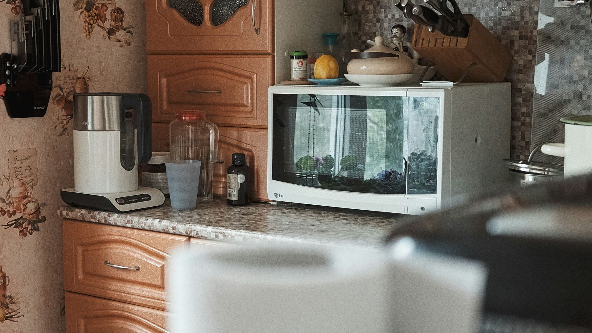 white microwave oven on brown wooden cabinet