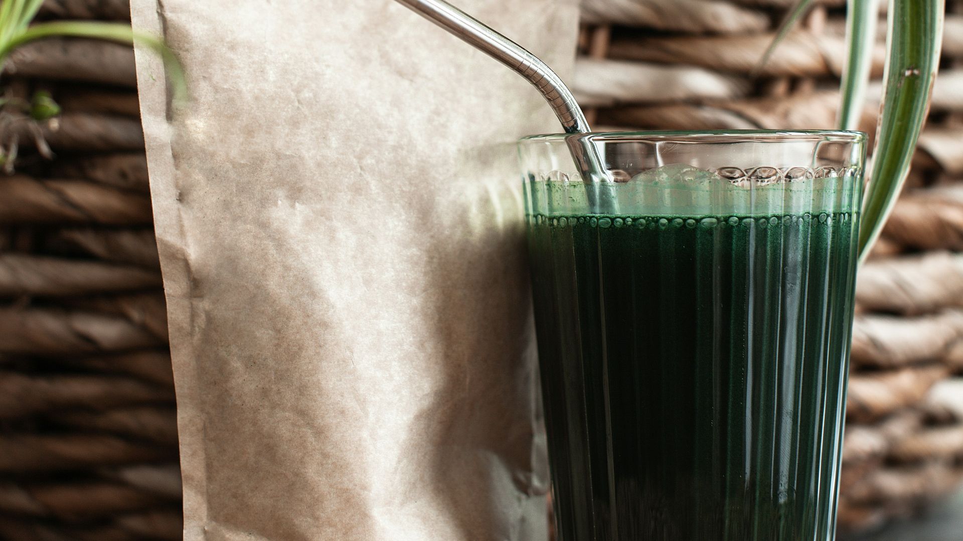 a couple of glass vases with plants in them