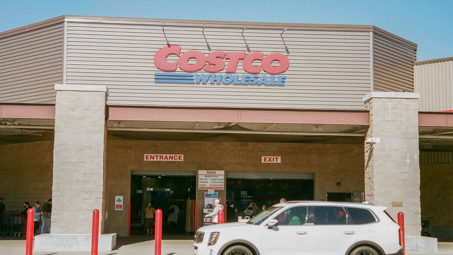 a white car parked in front of a costco store
