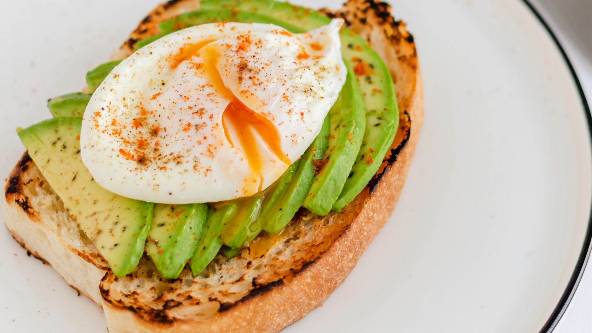 a sandwich with an egg and asparagus on it