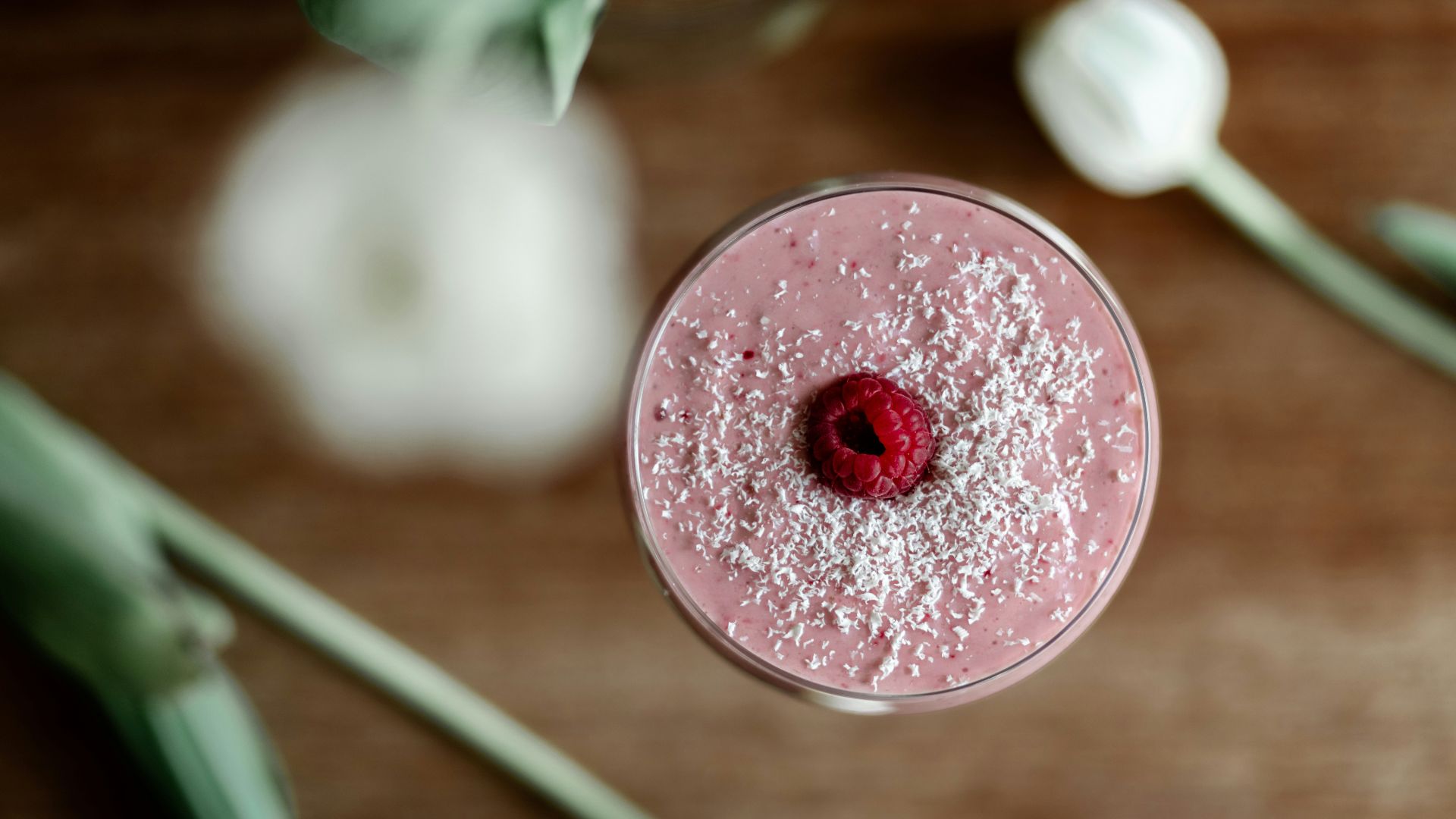 a pink drink with a raspberry in it