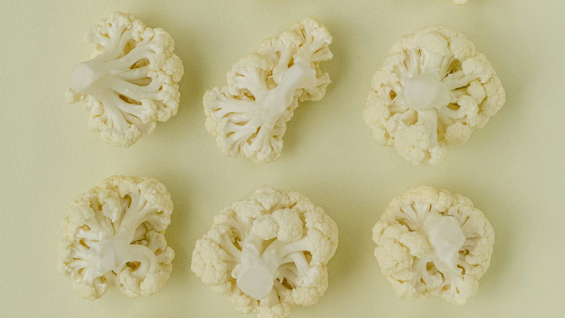 a bunch of cauliflower on a white surface