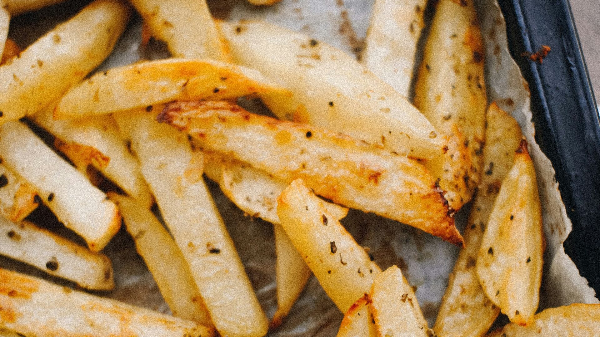 a pan filled with french fries on top of a table