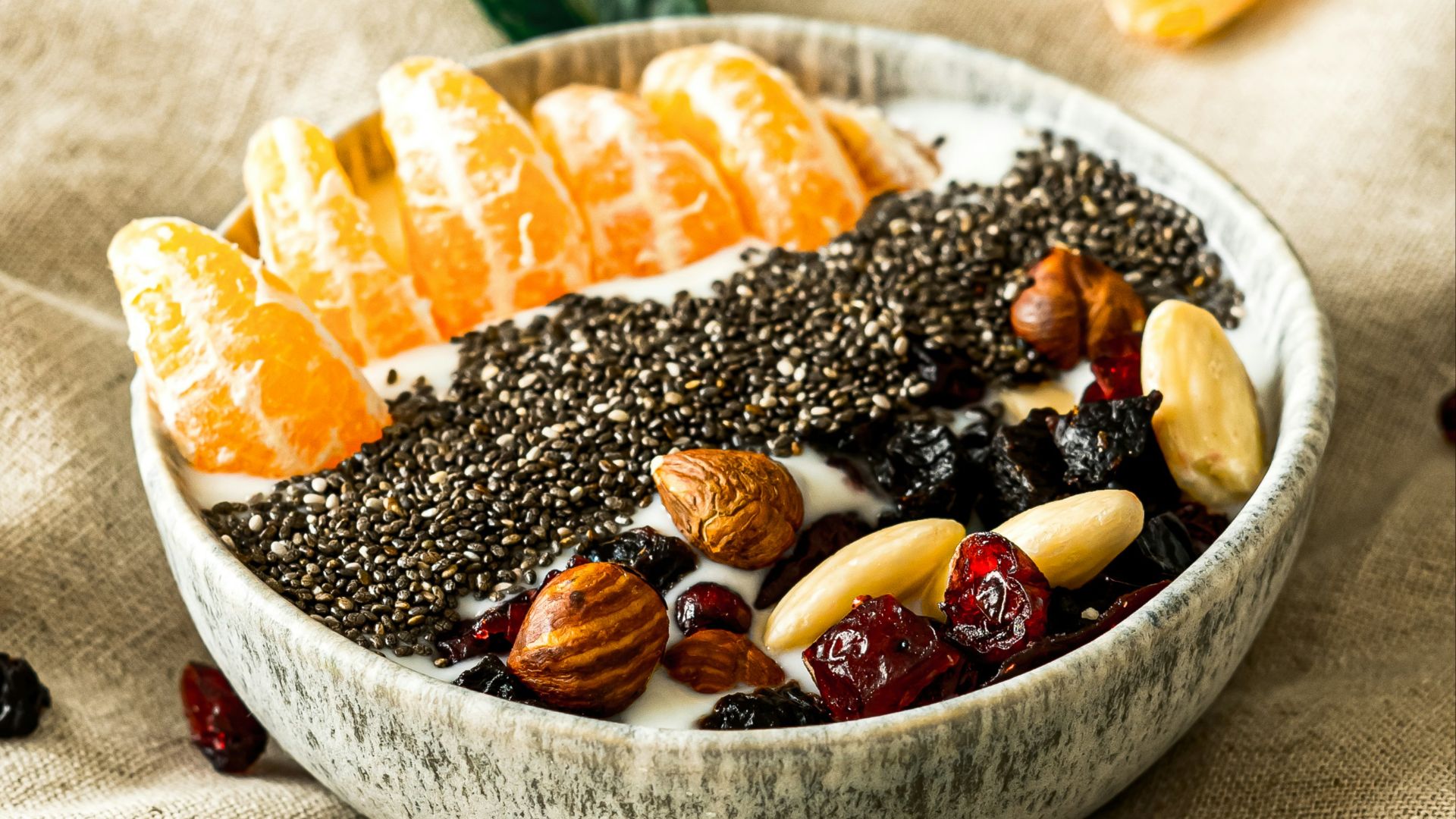 a bowl filled with fruit and nuts on top of a table