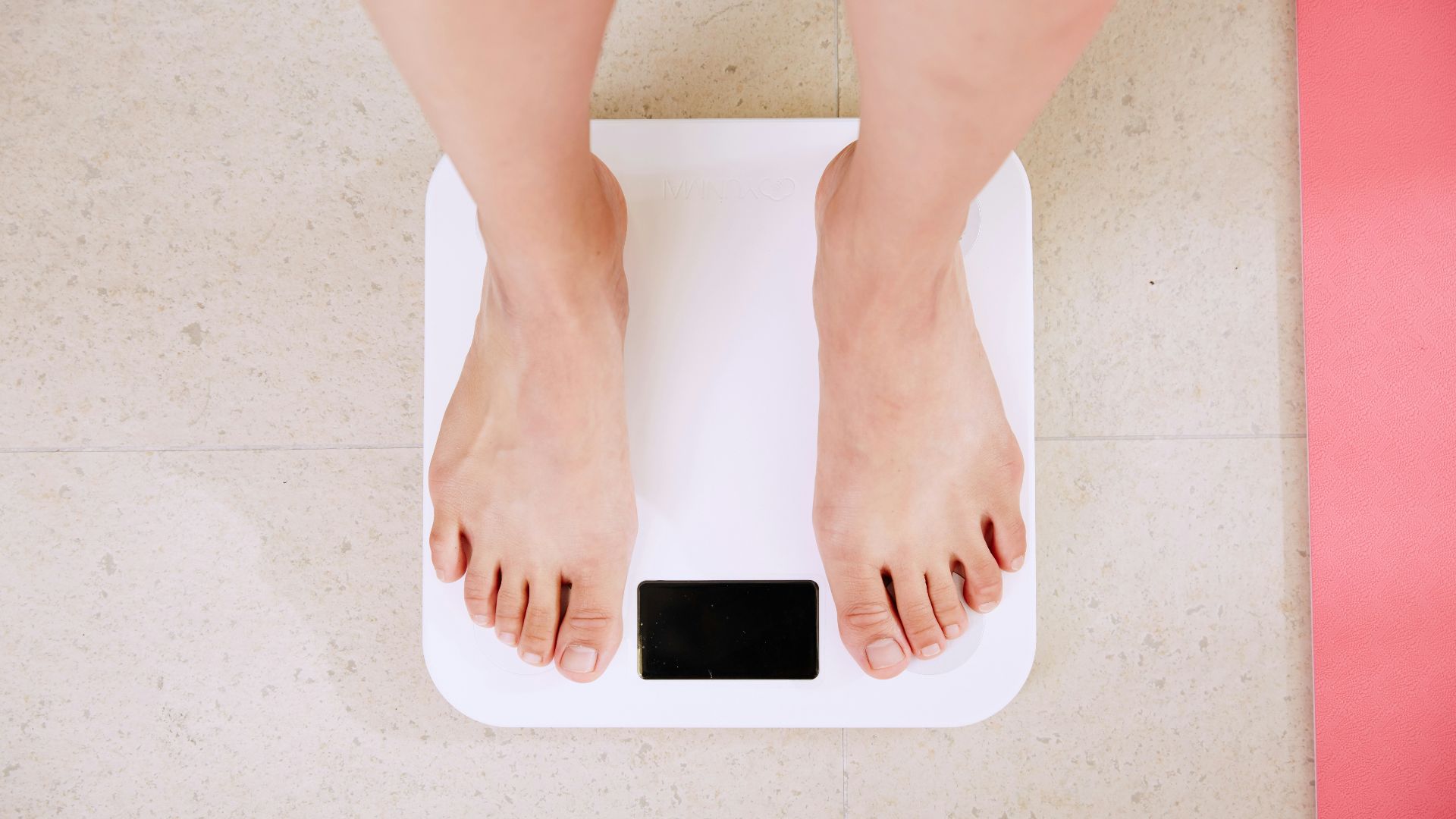 person standing on white digital bathroom scale