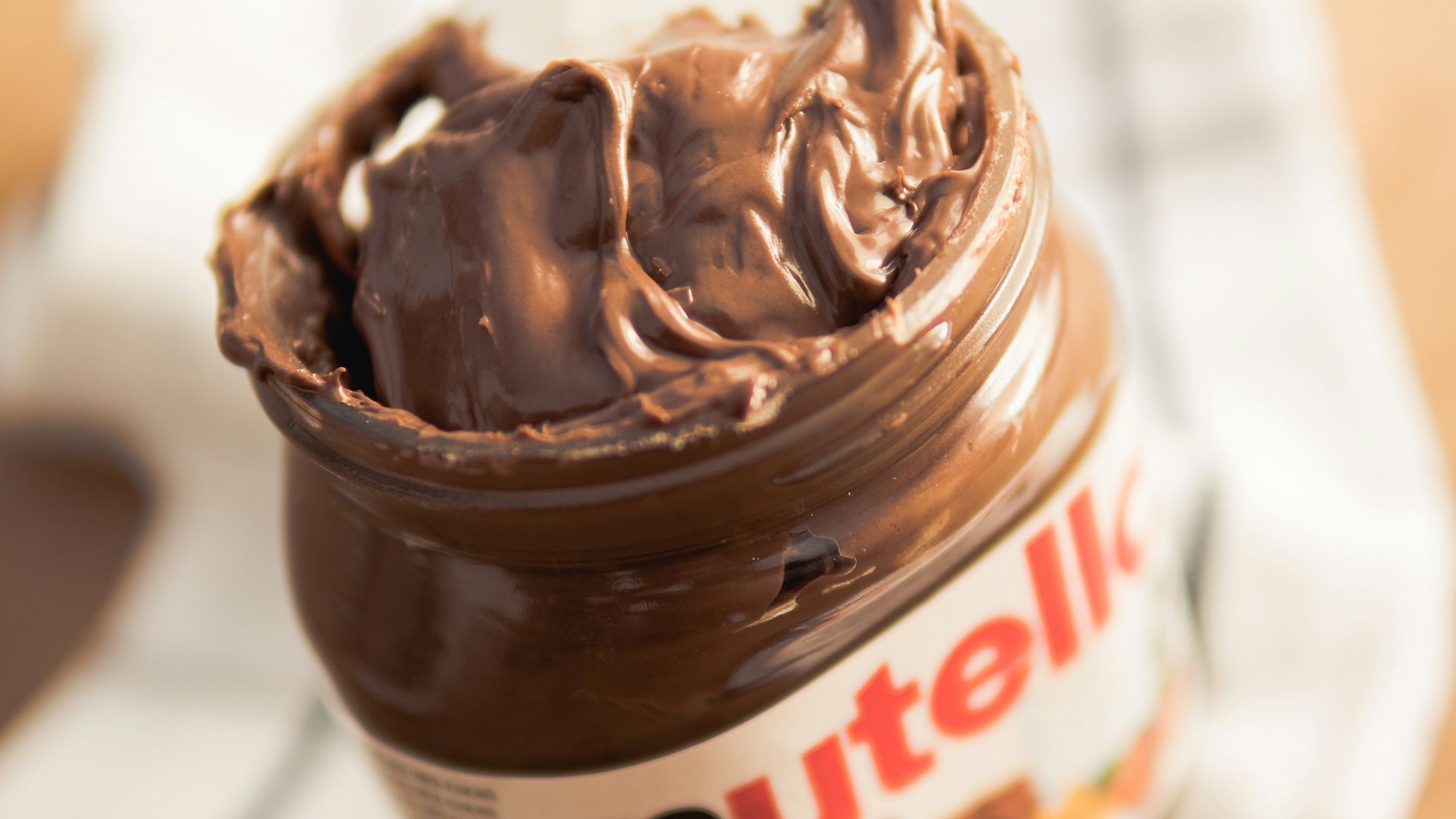 Nutella plastic container on white textile