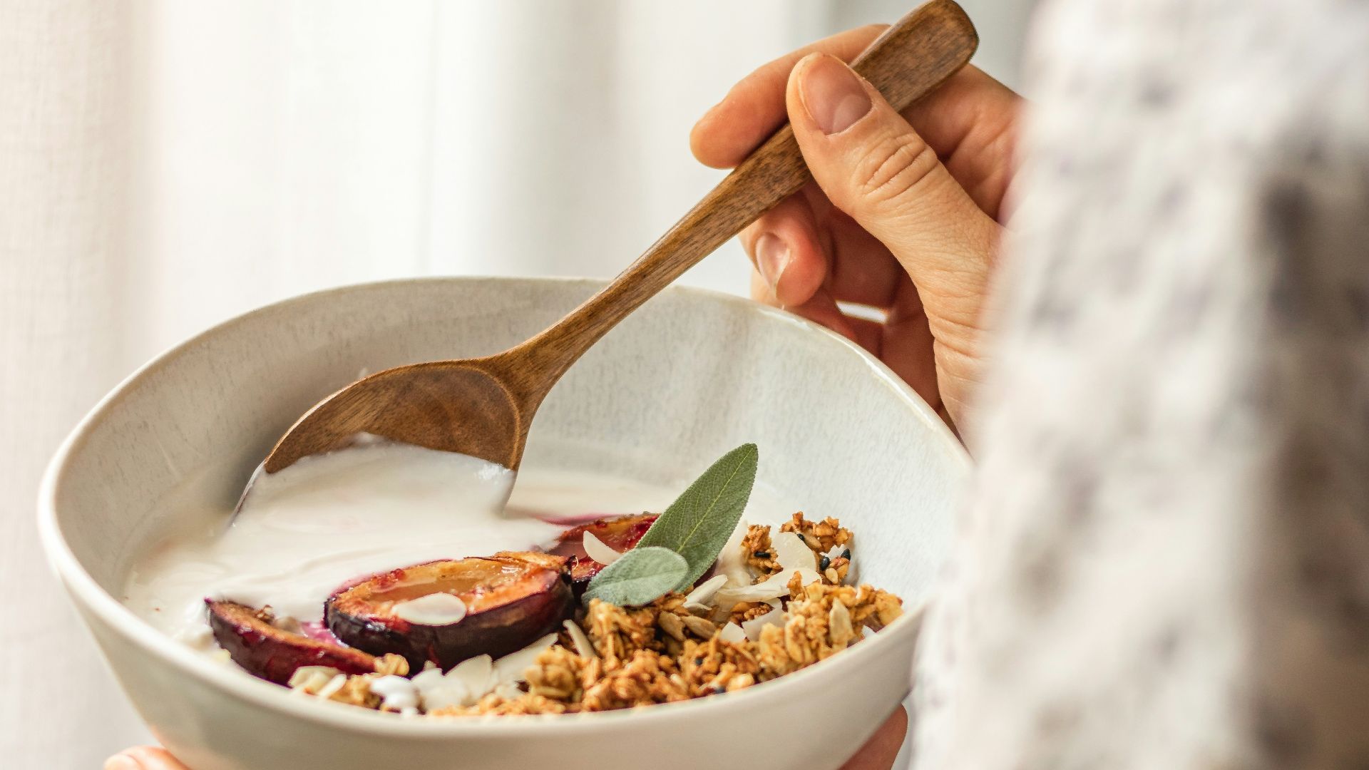 person holding white ceramic bowl with food