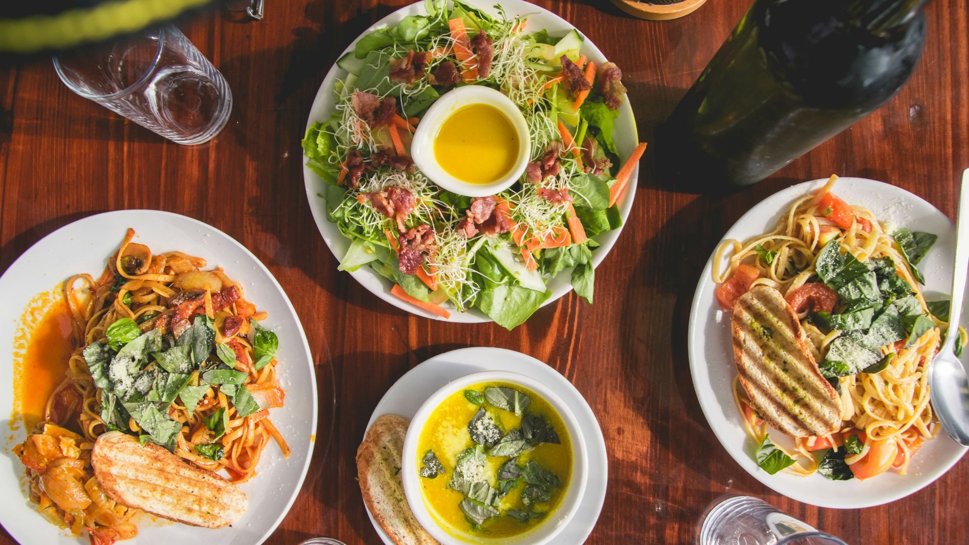 four assorted dishes on wooden surface